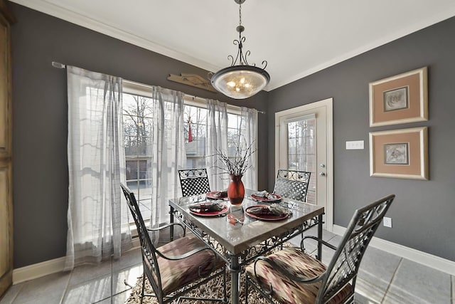 dining space featuring ornamental molding and light tile patterned floors