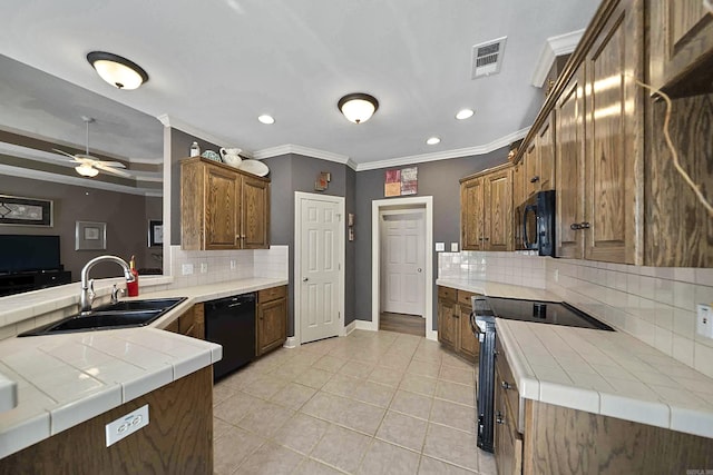 kitchen featuring sink, tile countertops, black appliances, and kitchen peninsula