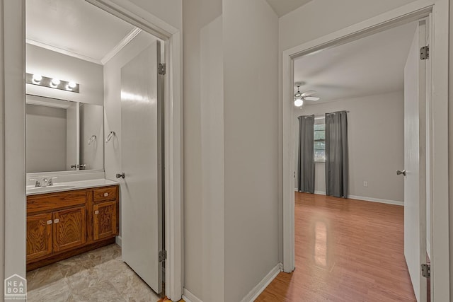 hall with sink and ornamental molding