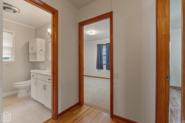 bathroom featuring hardwood / wood-style flooring, ornamental molding, vanity, and toilet