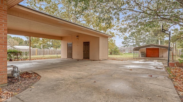 view of patio / terrace featuring an outbuilding and a carport