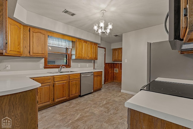 kitchen featuring an inviting chandelier, hanging light fixtures, stainless steel appliances, and sink