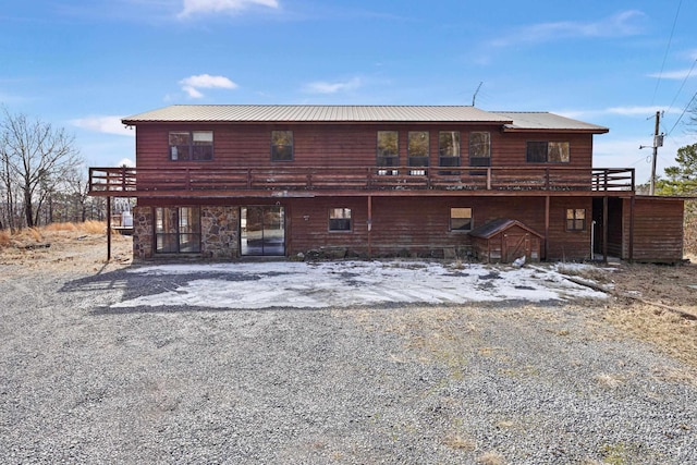 rear view of property featuring a wooden deck