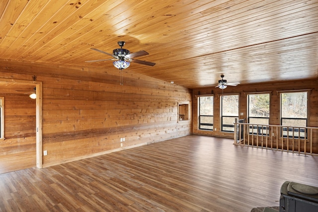 unfurnished living room featuring wood ceiling, vaulted ceiling, wooden walls, and dark wood-type flooring