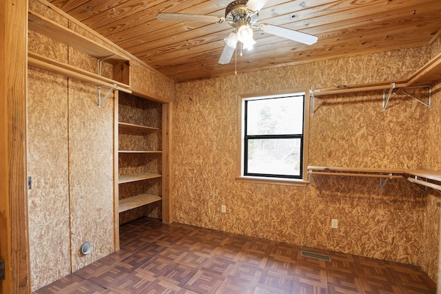 interior space with dark parquet floors and ceiling fan