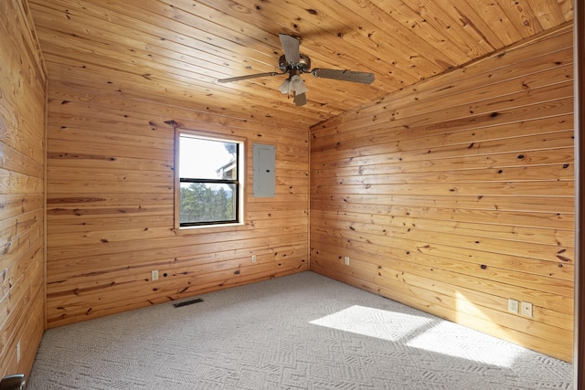 unfurnished room with wood walls, vaulted ceiling, carpet, and wooden ceiling