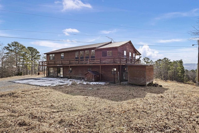 back of property featuring a deck and a patio area