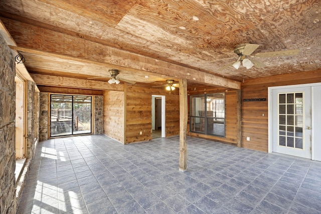 unfurnished sunroom featuring wooden ceiling and ceiling fan