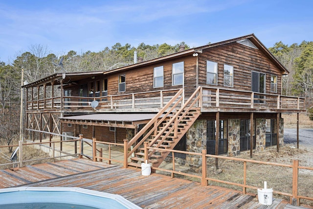 rear view of house with a wooden deck