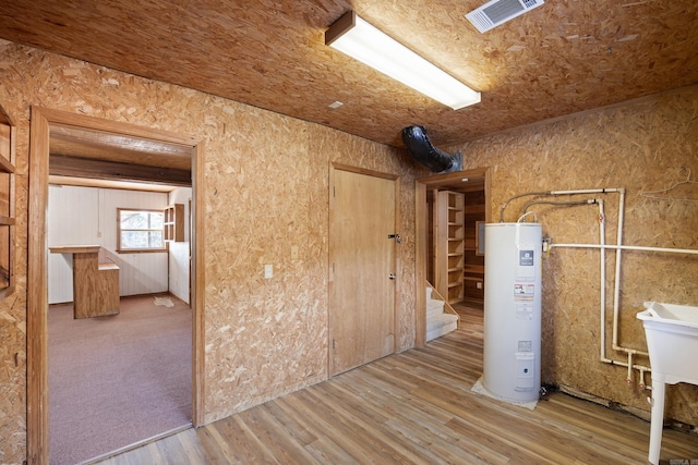 interior space featuring wood ceiling, light hardwood / wood-style floors, and water heater