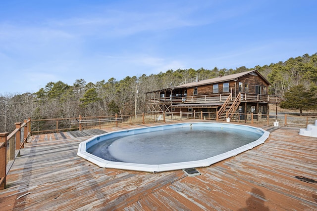 view of pool with a wooden deck