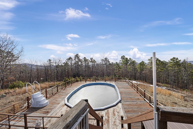 deck featuring a fenced in pool