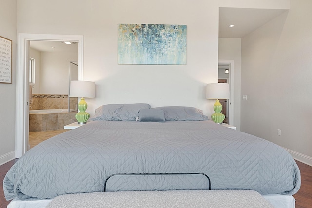 bedroom featuring ensuite bathroom and hardwood / wood-style floors