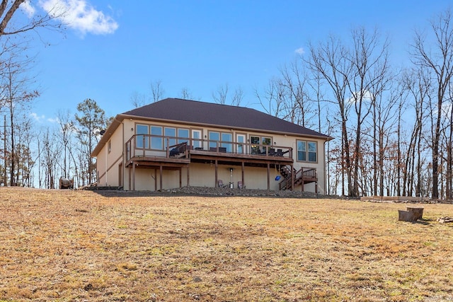 back of property featuring a yard and a deck