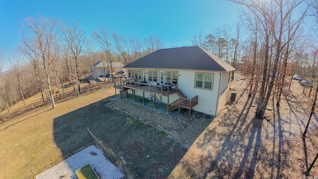 rear view of house featuring central AC, a yard, and a deck