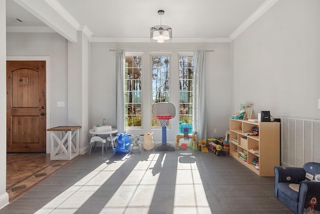 recreation room featuring crown molding