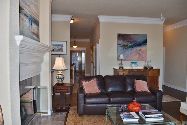 living room featuring baseboards, ornamental molding, and a fireplace