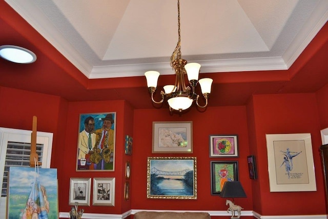 room details with an inviting chandelier, fridge, ornamental molding, and a raised ceiling