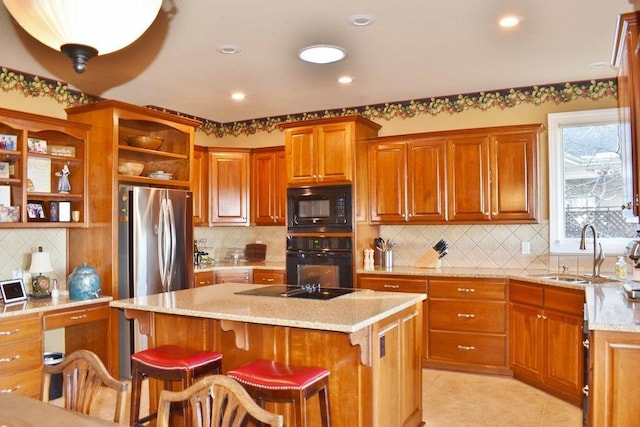 kitchen with light tile patterned floors, light stone countertops, open shelves, a sink, and black appliances