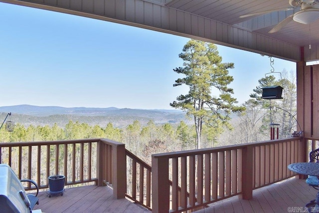 wooden deck featuring ceiling fan and a mountain view