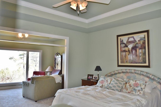 carpeted bedroom featuring crown molding, ceiling fan, and a raised ceiling