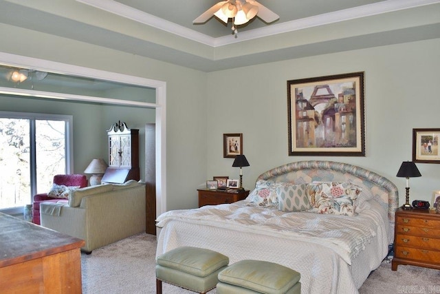 bedroom featuring ceiling fan, ornamental molding, a tray ceiling, and light carpet