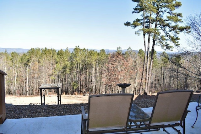 view of patio with a wooded view