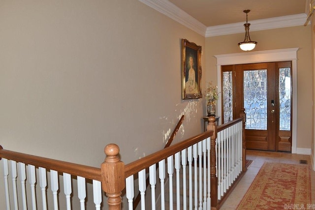 foyer entrance featuring crown molding and light tile patterned floors