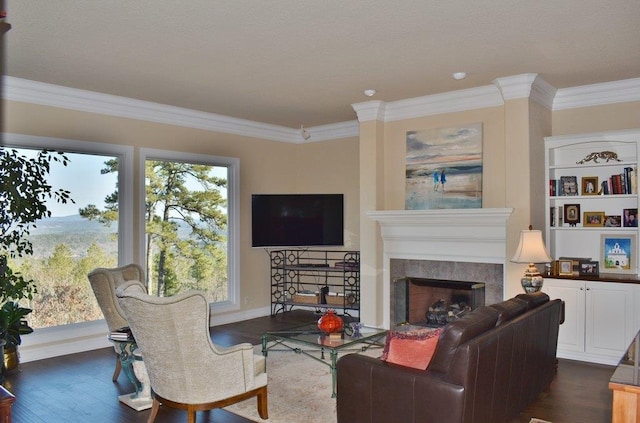 living room with crown molding, dark hardwood / wood-style floors, and a fireplace