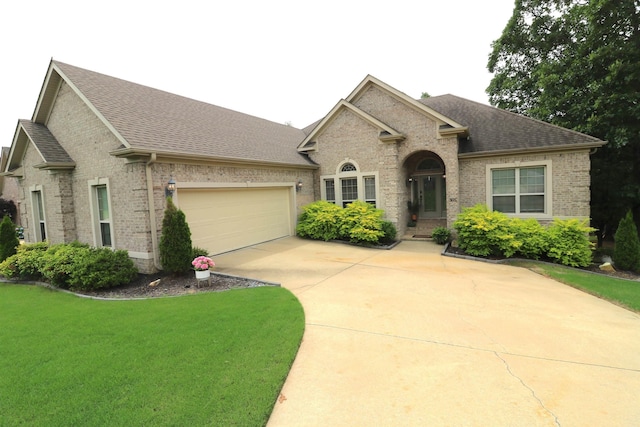 view of front of property featuring a garage and a front lawn