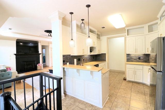 kitchen with white cabinetry, pendant lighting, and kitchen peninsula