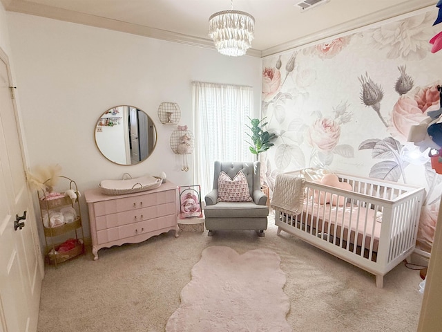 carpeted bedroom with a nursery area, crown molding, and an inviting chandelier