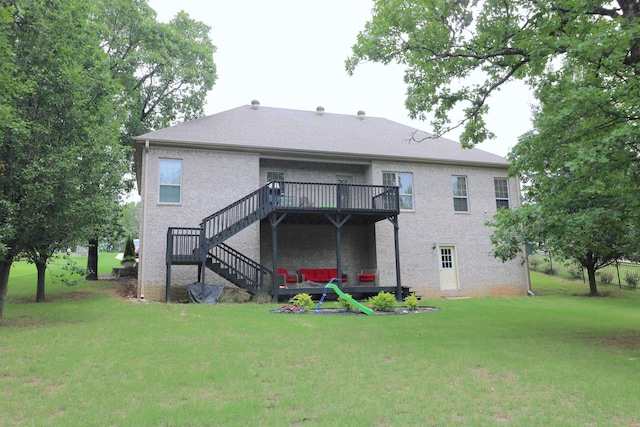 back of property featuring a wooden deck and a yard