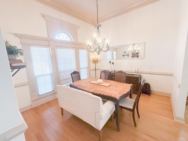 dining space with crown molding and light wood-type flooring