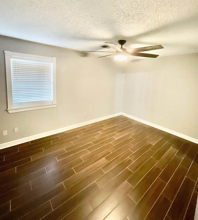 empty room featuring dark wood-type flooring and ceiling fan
