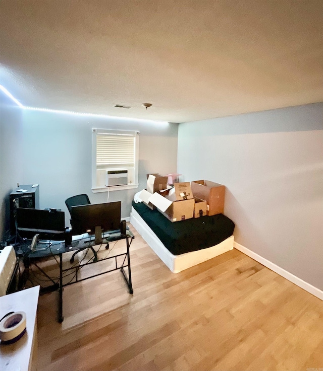 bedroom featuring cooling unit and wood-type flooring