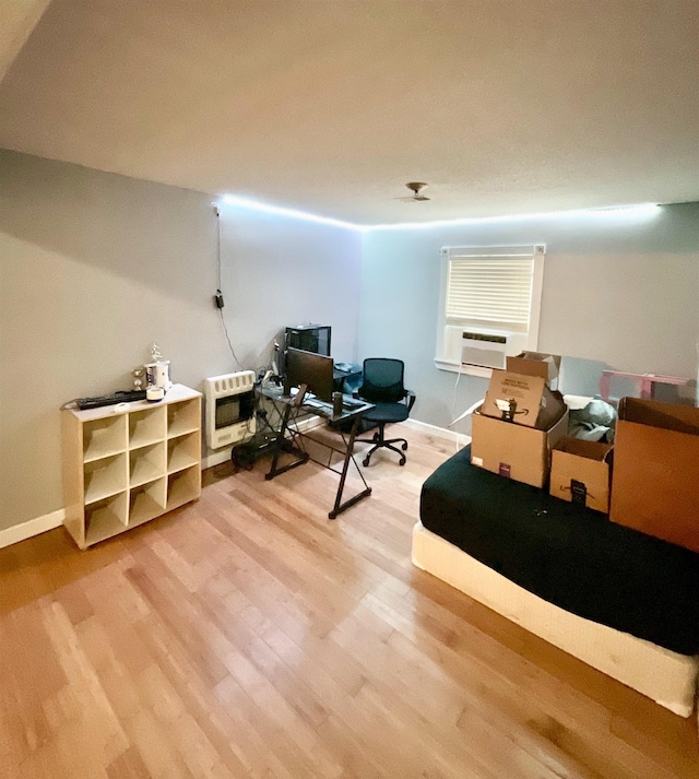office space featuring wood-type flooring and heating unit