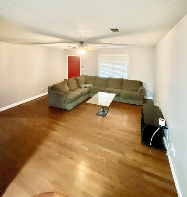 living room with hardwood / wood-style floors and ceiling fan