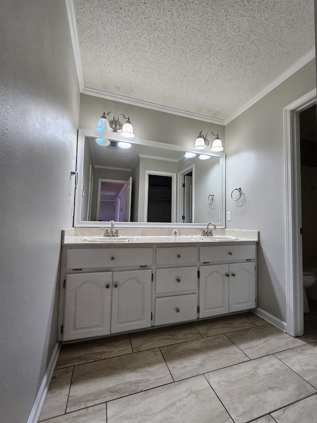 bathroom with vanity, crown molding, toilet, and a textured ceiling