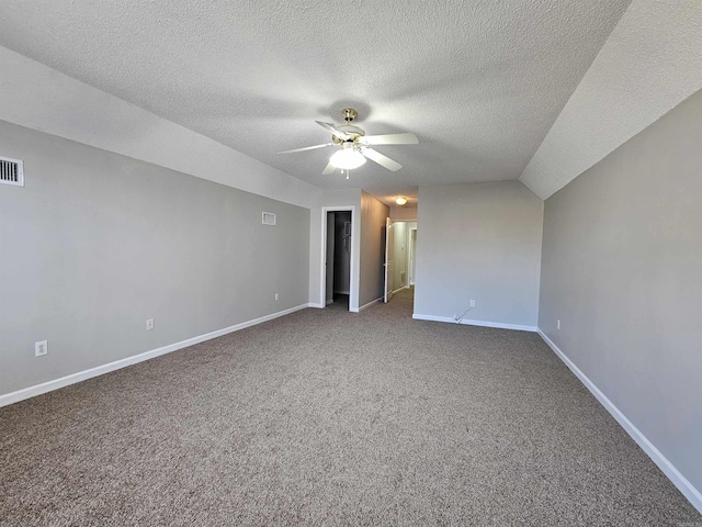 interior space with lofted ceiling, carpet, a textured ceiling, and ceiling fan