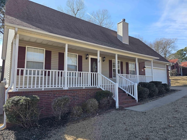 view of front of house with a porch and a garage