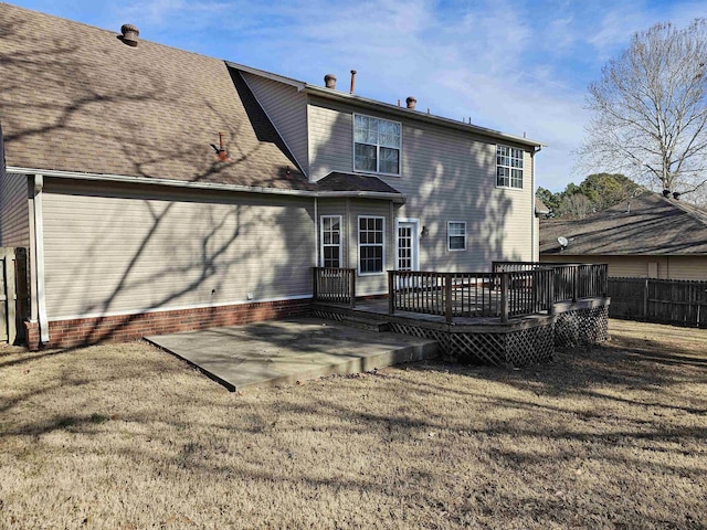 rear view of house featuring a yard, a deck, and a patio