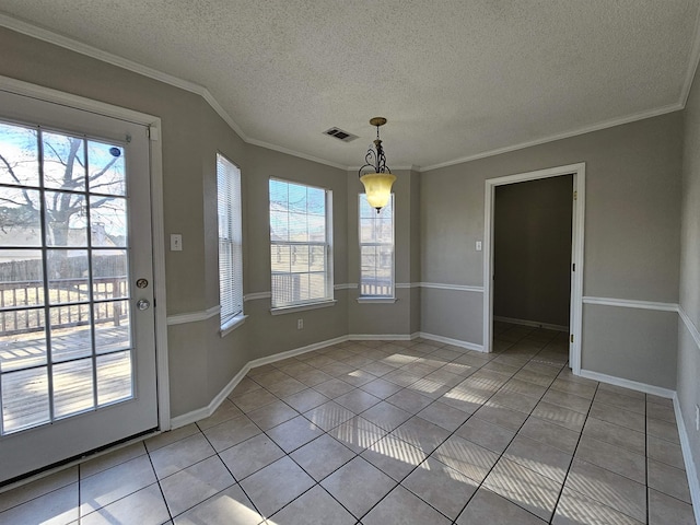 unfurnished dining area with crown molding, a textured ceiling, and light tile patterned floors