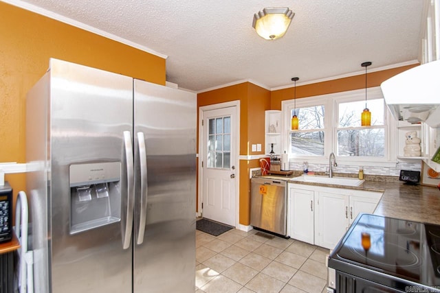 kitchen featuring light tile patterned floors, sink, hanging light fixtures, stainless steel appliances, and white cabinets