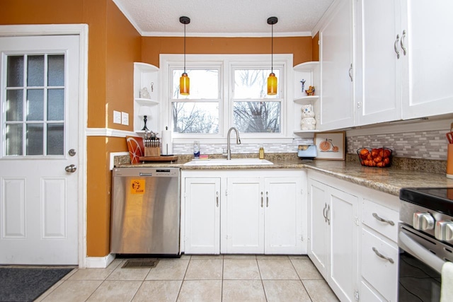 kitchen with decorative light fixtures, white cabinetry, sink, backsplash, and stainless steel appliances