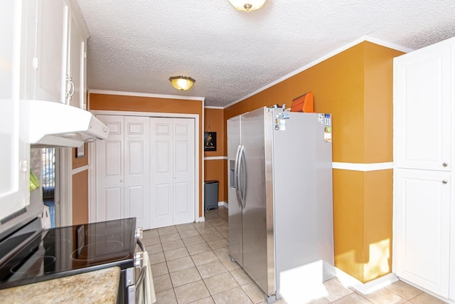 kitchen featuring crown molding, stainless steel appliances, light tile patterned floors, and white cabinets