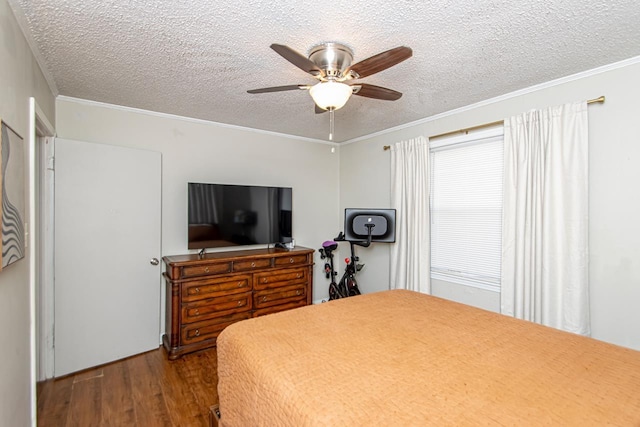 bedroom featuring ornamental molding, hardwood / wood-style floors, a textured ceiling, and ceiling fan