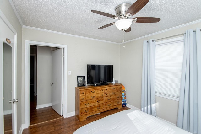 bedroom with crown molding, ceiling fan, dark hardwood / wood-style floors, and a textured ceiling