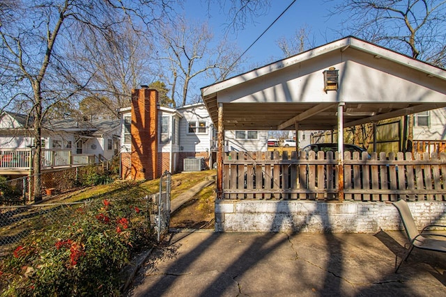 exterior space featuring cooling unit and a carport