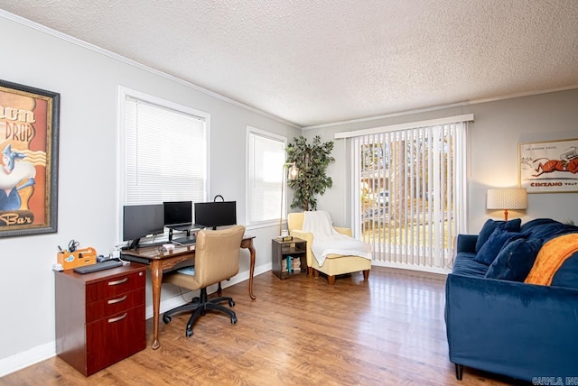 office featuring wood-type flooring, crown molding, and a textured ceiling